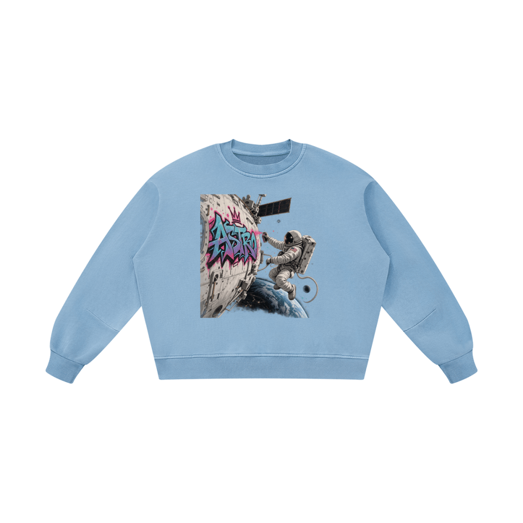 Light blue ASTRO Space Graffiti boxy vintage-washed sweatshirt, front view with an astronaut and turquoise and pink spacecraft tag.
