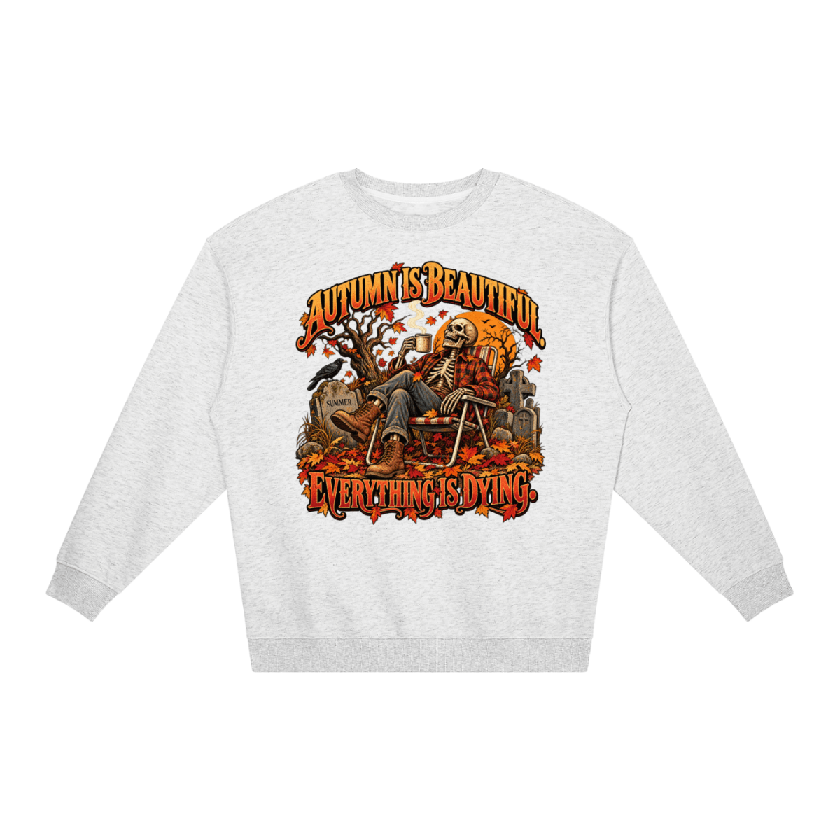Light gray Autumn Is Beautiful Everything Is Dying loose crewneck sweatshirt, front view with a seated skeleton surrounded by autumn leaves beneath Autumn Is Beautiful Everything Is Dying lettering.