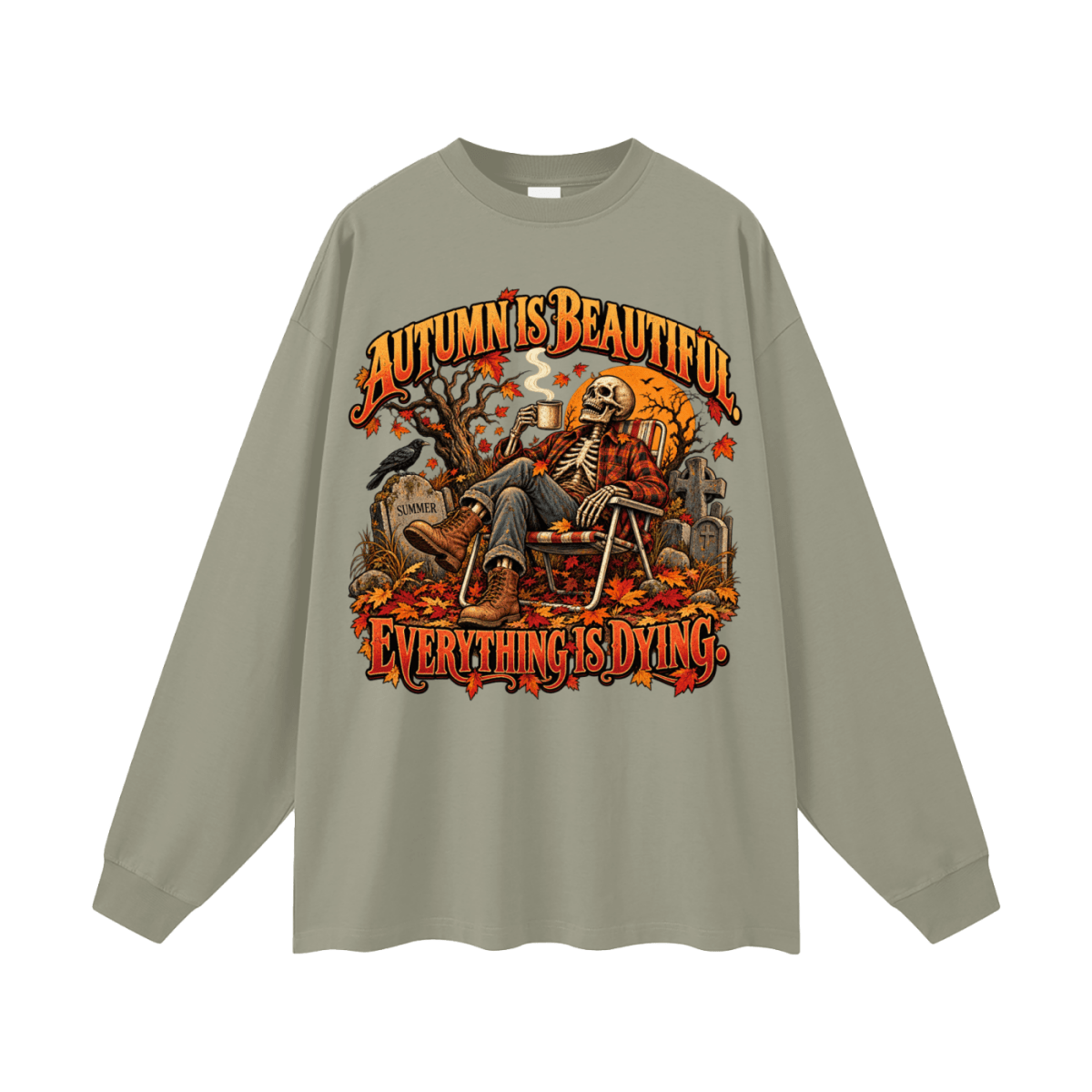 Sage green Autumn Is Beautiful long-sleeve T-shirt, front view with a seated skeleton, fall leaves and orange lettering.