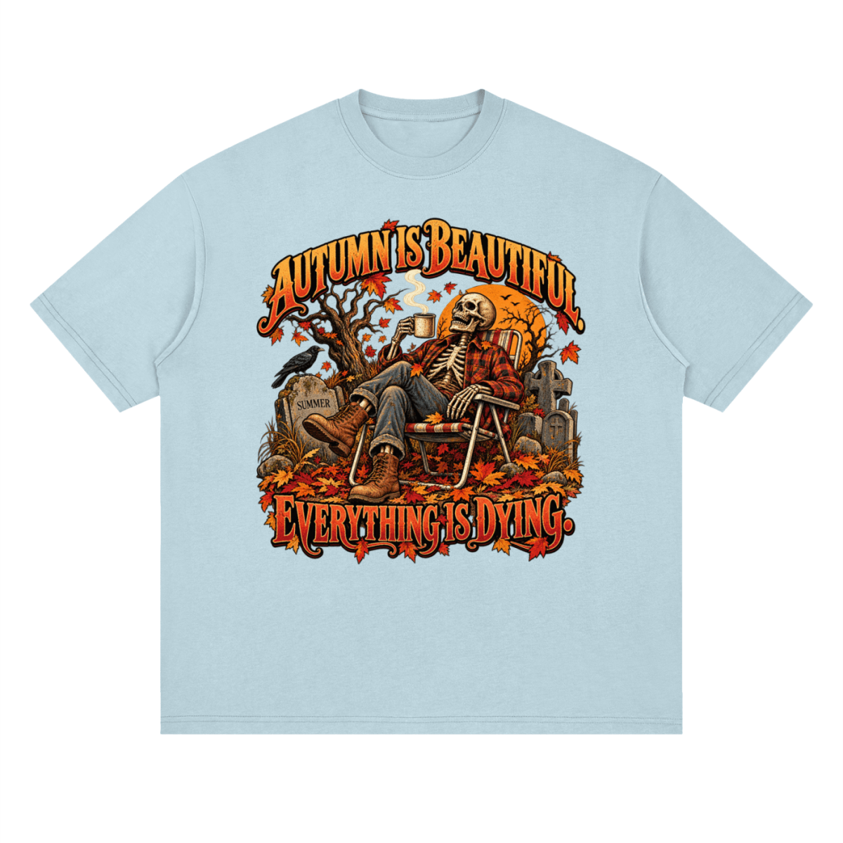 Pale blue Autumn Is Beautiful drop-shoulder T-shirt, front view with a seated skeleton, fall leaves and orange lettering.