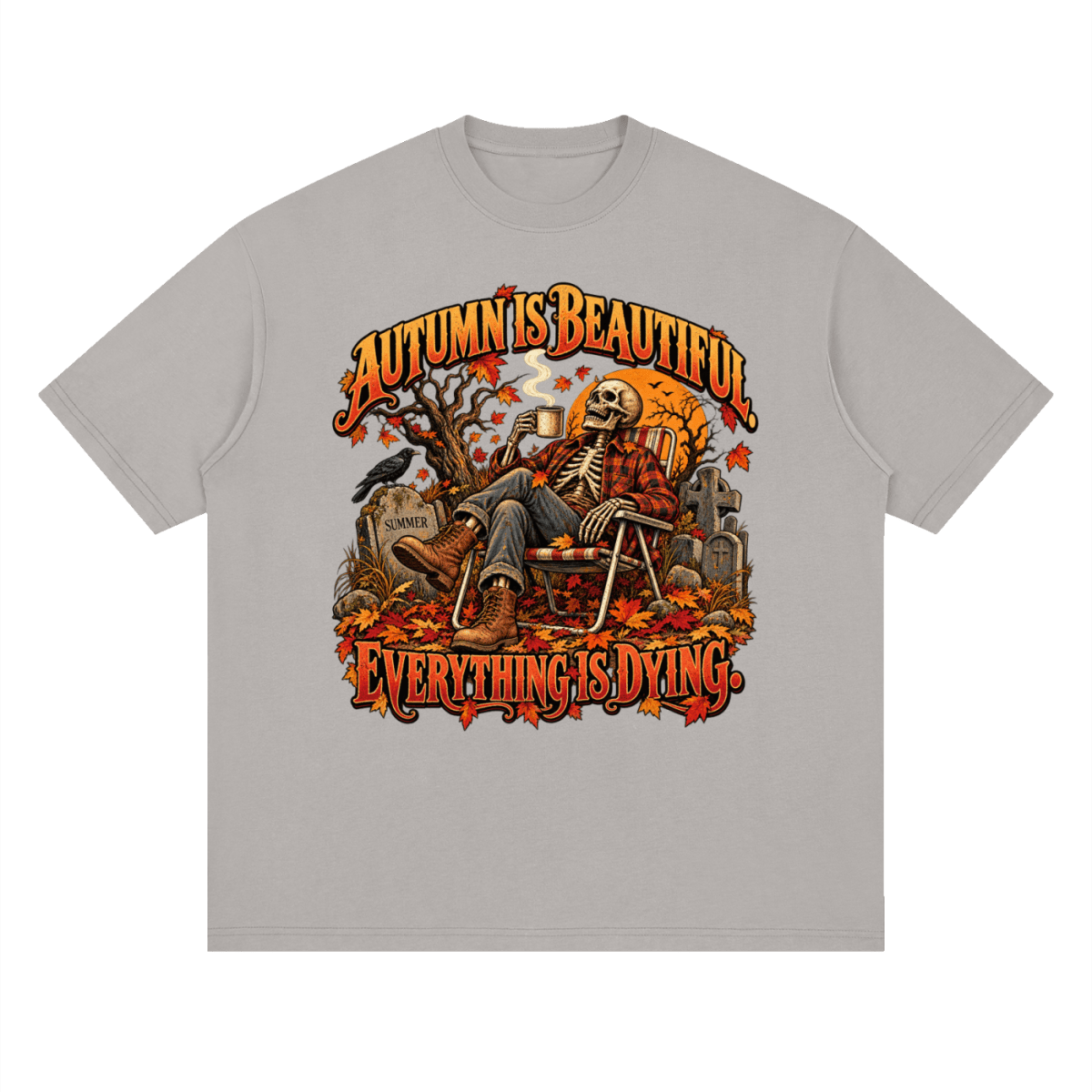 Light gray Autumn Is Beautiful drop-shoulder T-shirt, front view with a seated skeleton, fall leaves and orange lettering.