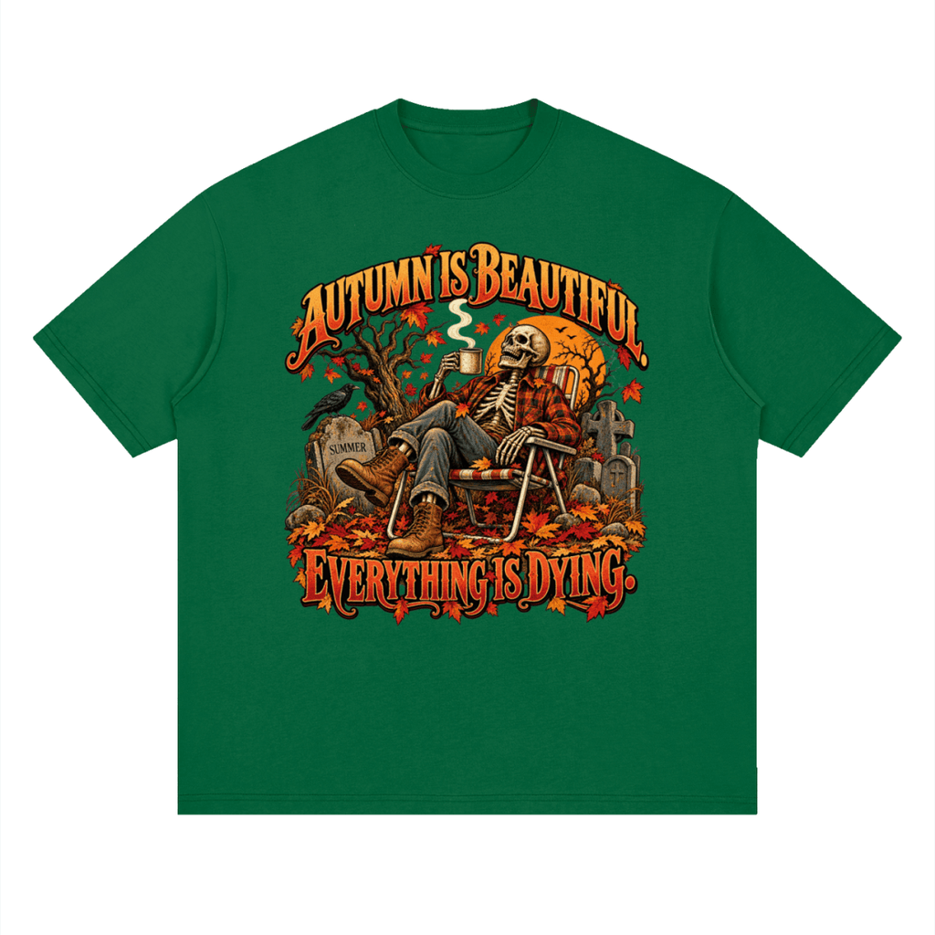 Green Autumn Is Beautiful drop-shoulder T-shirt, front view with a seated skeleton, fall leaves and orange lettering.