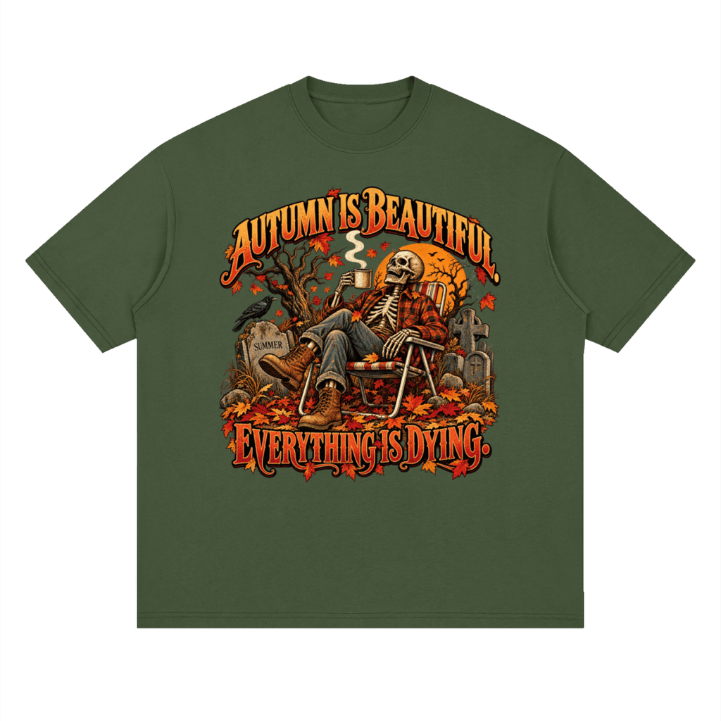 Olive green Autumn Is Beautiful drop-shoulder T-shirt, front view with a seated skeleton, fall leaves and orange lettering.