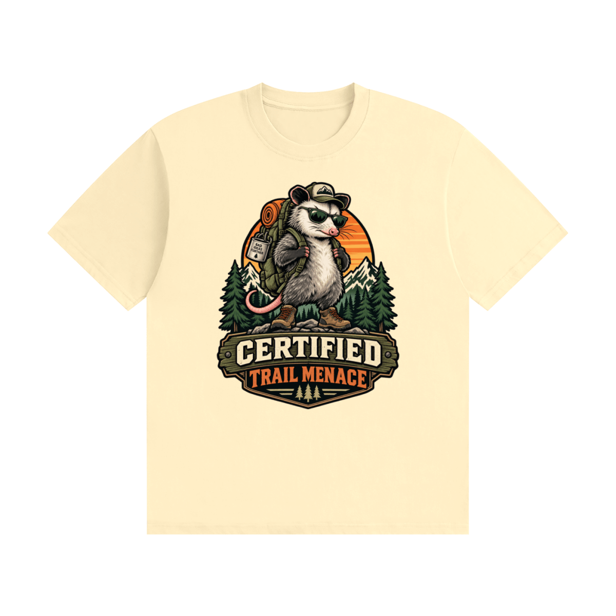 Cream cotton T-shirt, front view with a hiking possum with sunglasses and backpack against mountains and an orange sunset.