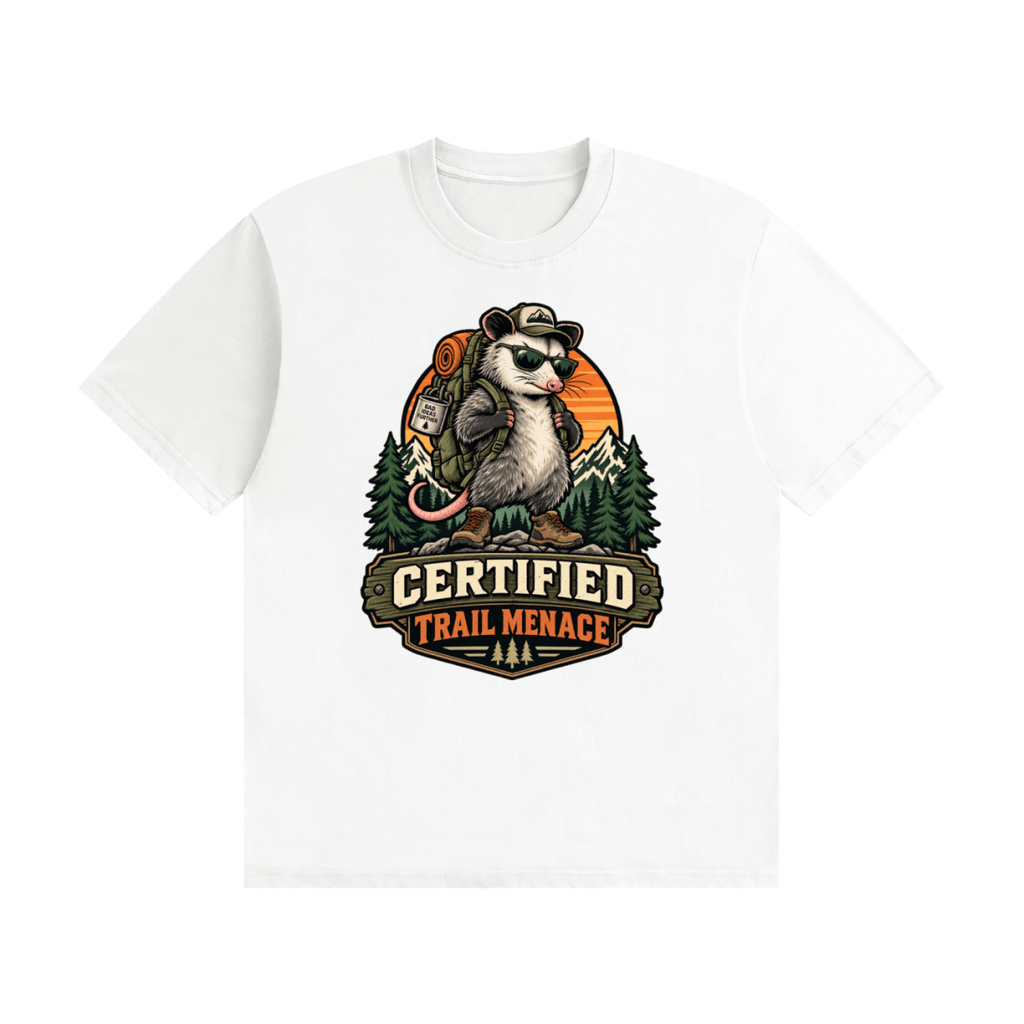 White cotton T-shirt, front view with a hiking possum with sunglasses and backpack against mountains and an orange sunset.