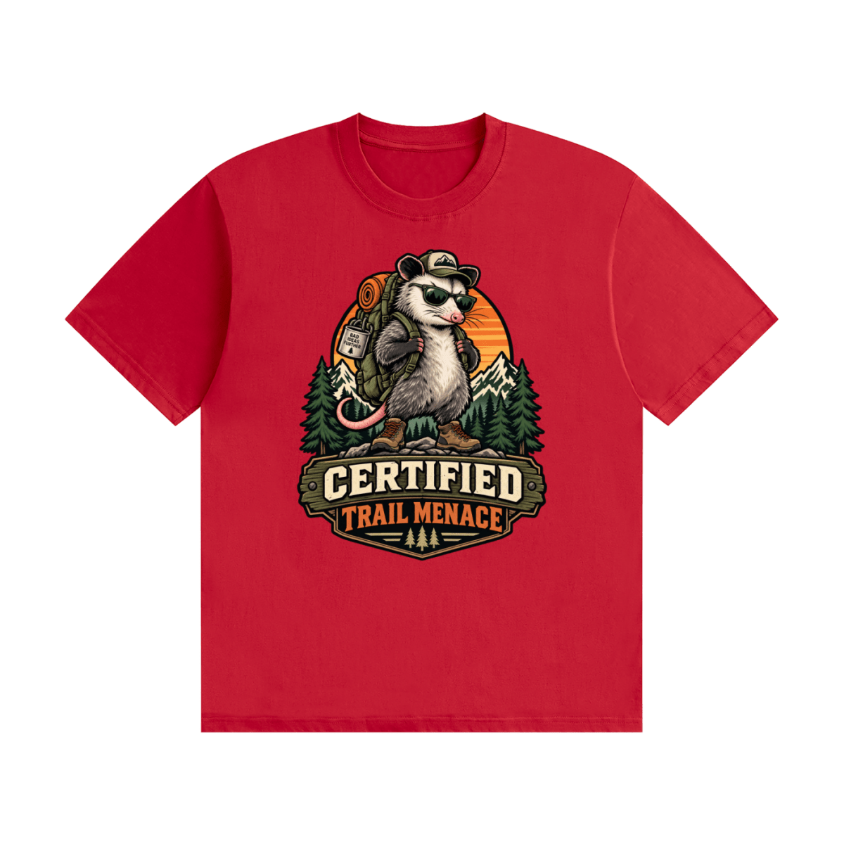 Red cotton T-shirt, front view with a hiking possum with sunglasses and backpack against mountains and an orange sunset.