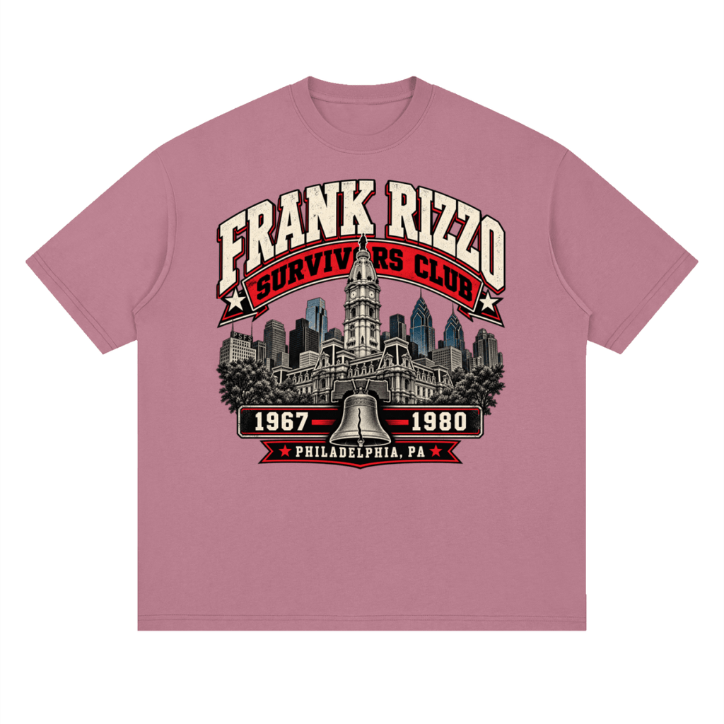 Dusty pink Frank Rizzo Survivors Club drop-shoulder T-shirt, front view with a Philadelphia skyline, bell and red and cream Survivors Club lettering.