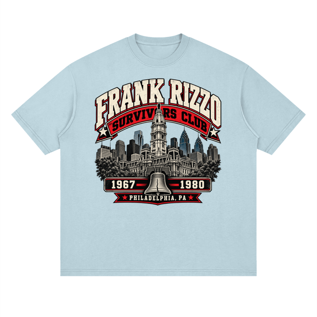 Pale blue Frank Rizzo Survivors Club drop-shoulder T-shirt, front view with a Philadelphia skyline, bell and red and cream Survivors Club lettering.