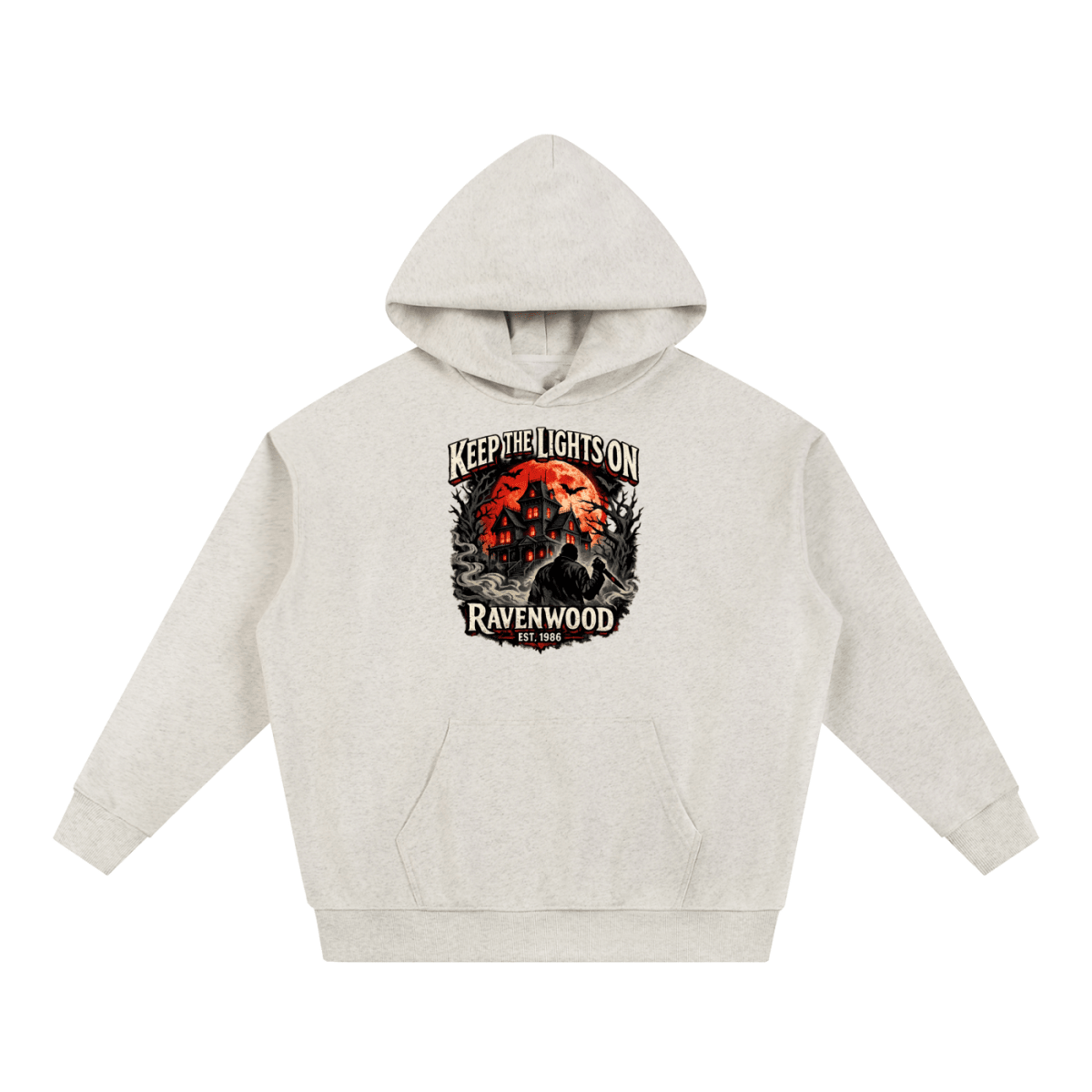 Oatmeal heavyweight hoodie, front view with a haunted house, orange moon and knife-holding silhouette with Keep the Lights On and Ravenwood Est. 1986 lettering.