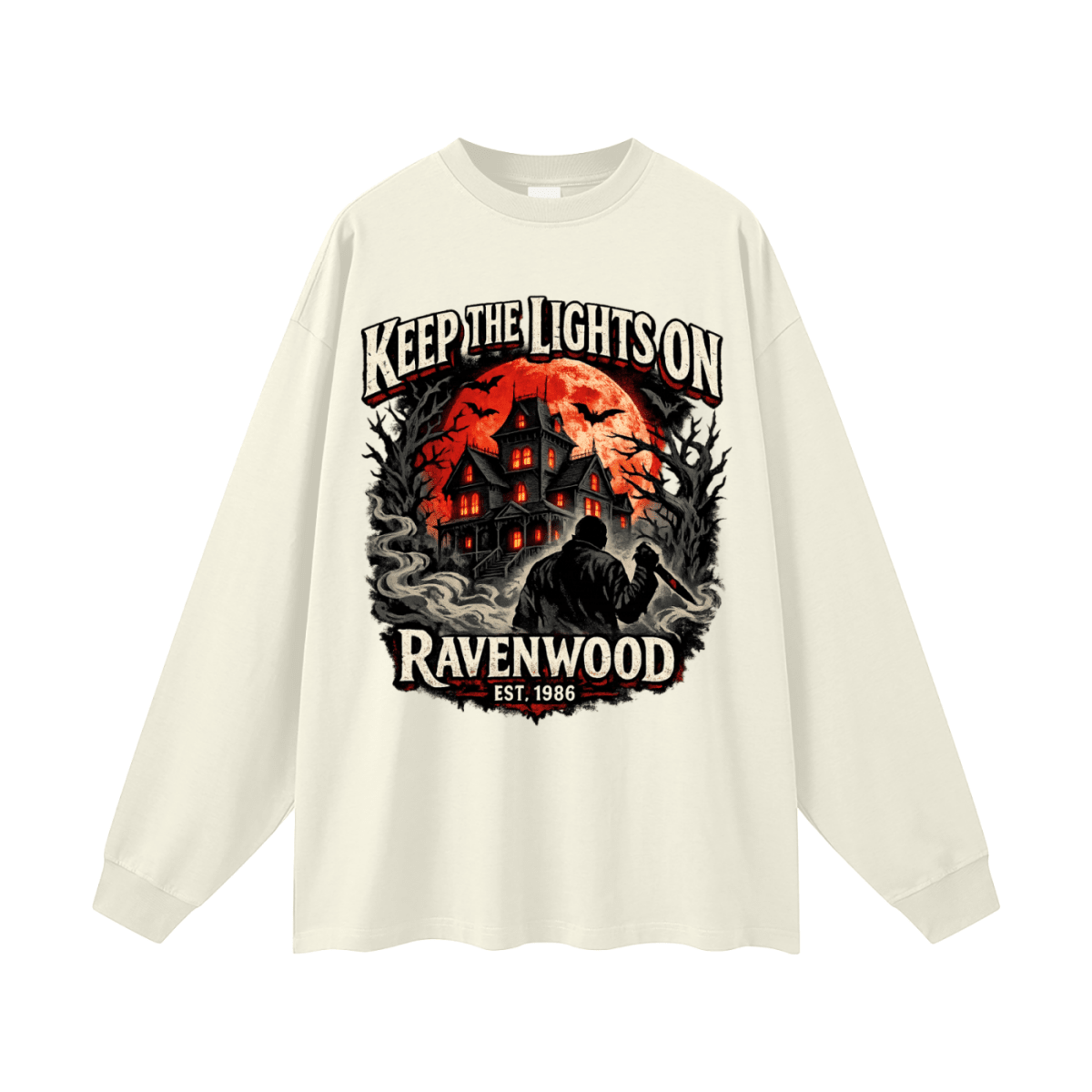 Ivory oversized long-sleeve T-shirt, front view with a haunted house, orange moon and knife-holding silhouette with Keep the Lights On and Ravenwood Est. 1986 lettering.