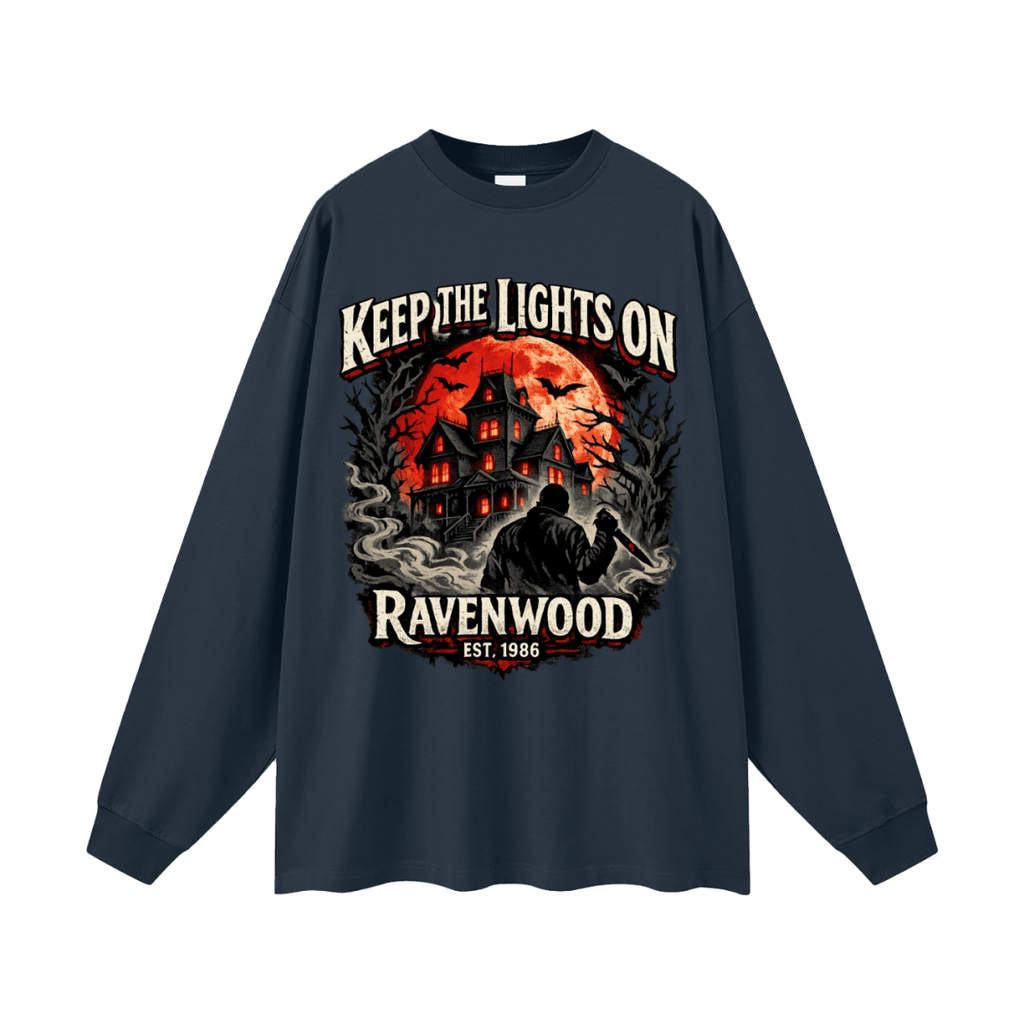 Navy blue oversized long-sleeve T-shirt, front view with a haunted house, orange moon and knife-holding silhouette with Keep the Lights On and Ravenwood Est. 1986 lettering.