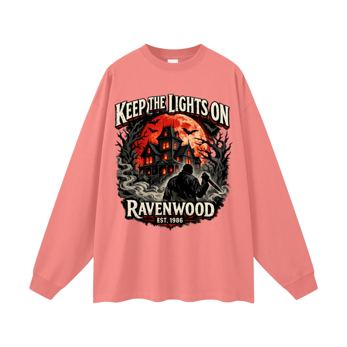 Coral pink oversized long-sleeve T-shirt, front view with a haunted house, orange moon and knife-holding silhouette with Keep the Lights On and Ravenwood Est. 1986 lettering.
