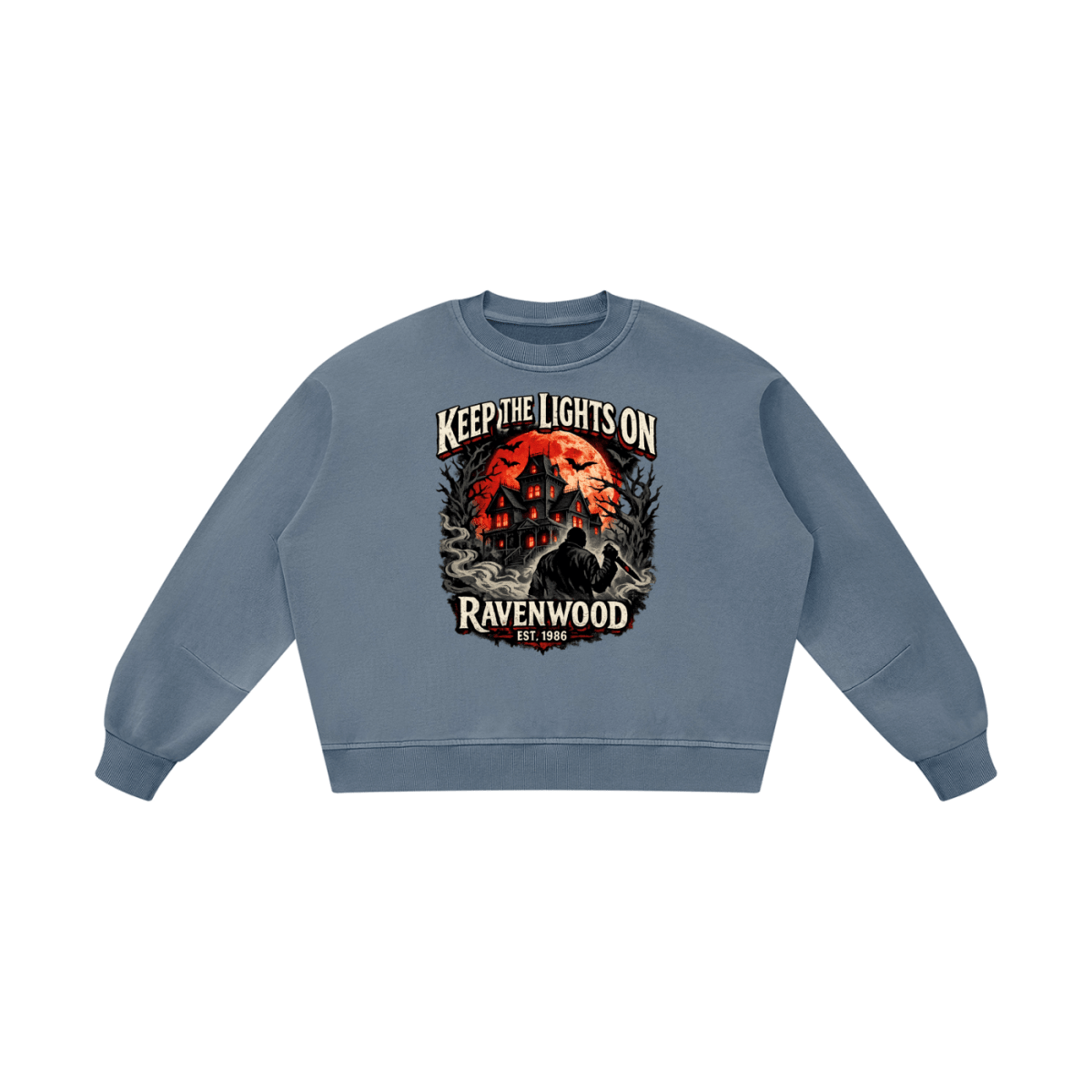 Blue gray boxy vintage-washed sweatshirt, front view with a haunted house, orange moon and knife-holding silhouette with Keep the Lights On and Ravenwood Est. 1986 lettering.