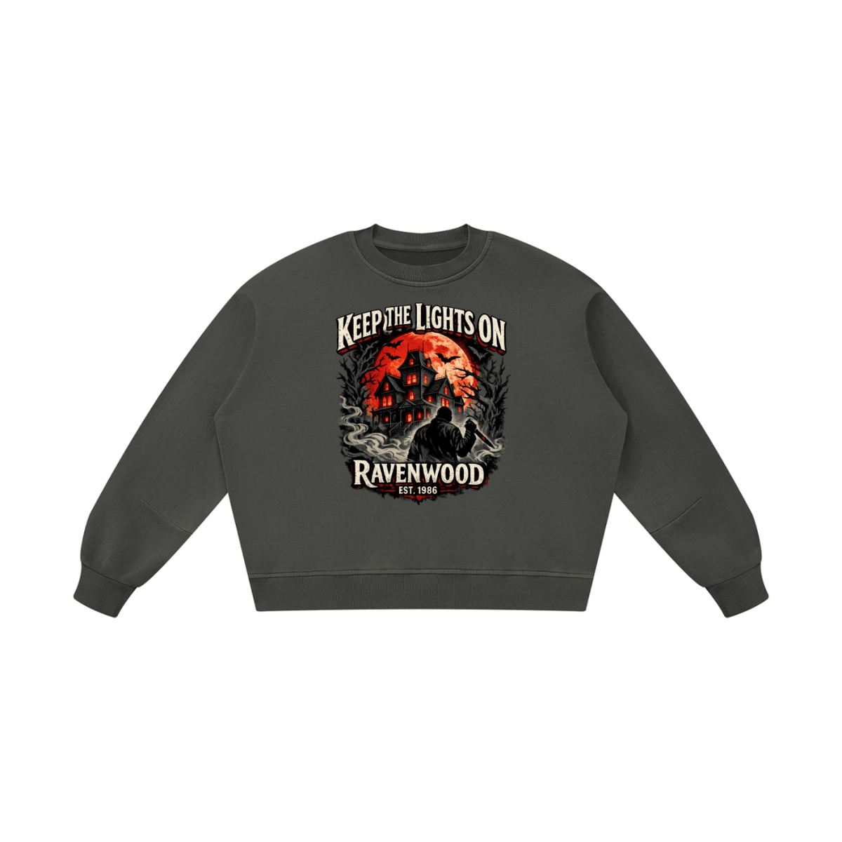 Dark gray boxy vintage-washed sweatshirt, front view with a haunted house, orange moon and knife-holding silhouette with Keep the Lights On and Ravenwood Est. 1986 lettering.