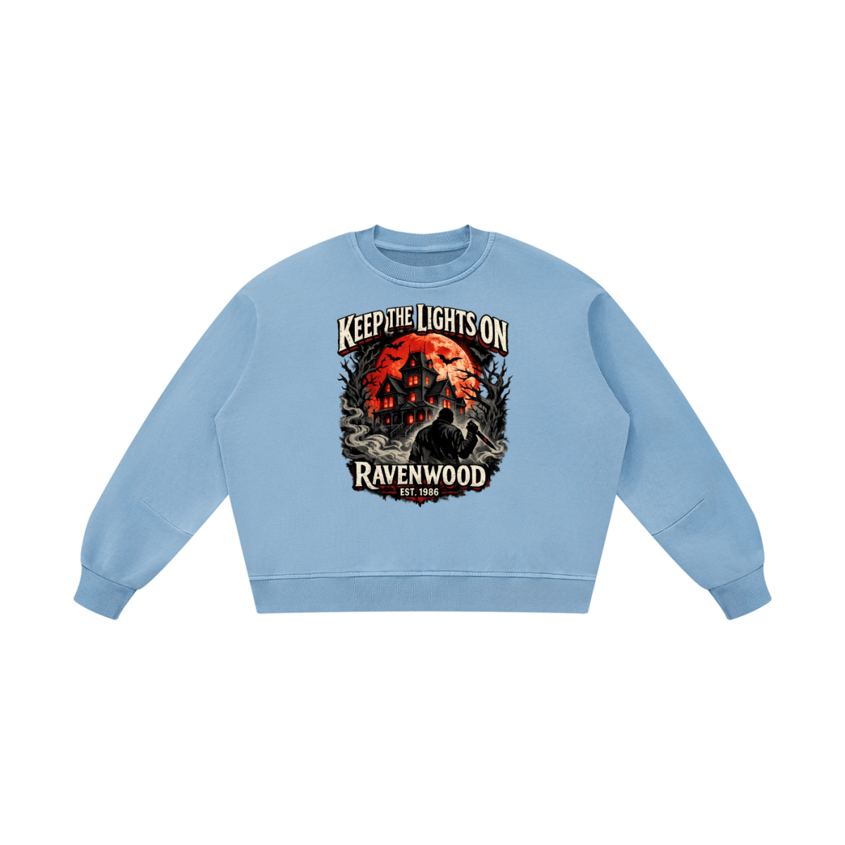 Light blue boxy vintage-washed sweatshirt, front view with a haunted house, orange moon and knife-holding silhouette with Keep the Lights On and Ravenwood Est. 1986 lettering.
