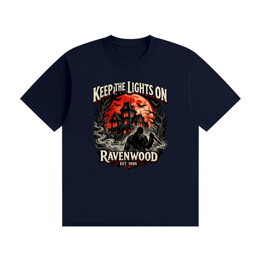Navy blue cotton T-shirt, front view with a haunted house, orange moon and knife-holding silhouette with Keep the Lights On and Ravenwood Est. 1986 lettering.