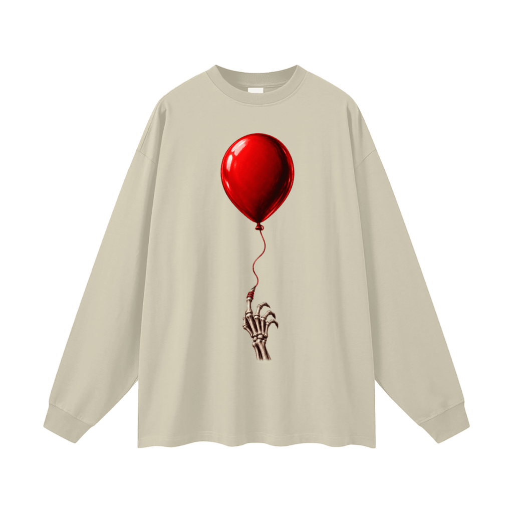 Beige The Last Balloon oversized long sleeve T-shirt, front view with a shiny red balloon tethered to a skeletal hand.
